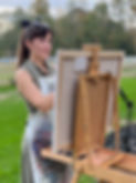 Raleigh fine artist, Katie Peña live wedding painting at an easel outdoors in North Carolina