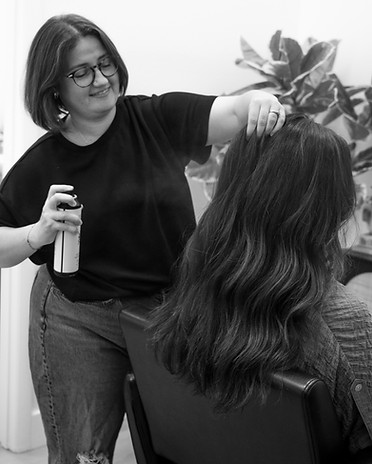 Amy styling a clients hair after a cut