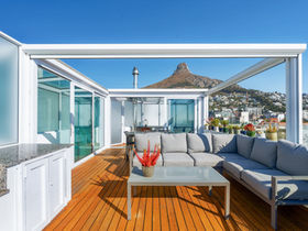 Modern rooftop patio with mountain view.