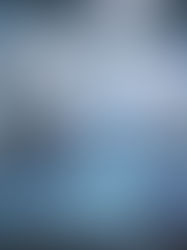 A holographic ERP dashboard displaying Bill of Materials data and analytics in a modern automated manufacturing plant.