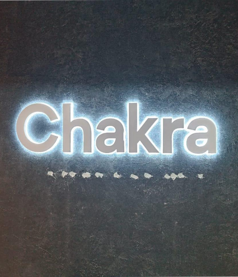 1. Illuminated sign reading "Chakra" in the dark, featuring backlit letters with white powder coating and LED lights.