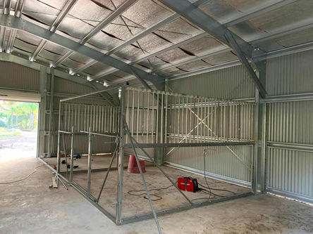 Internal horse stable framing inside steel shed in Pitt Town