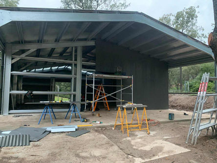 Front cladding installation on steel shed in Pitt Town