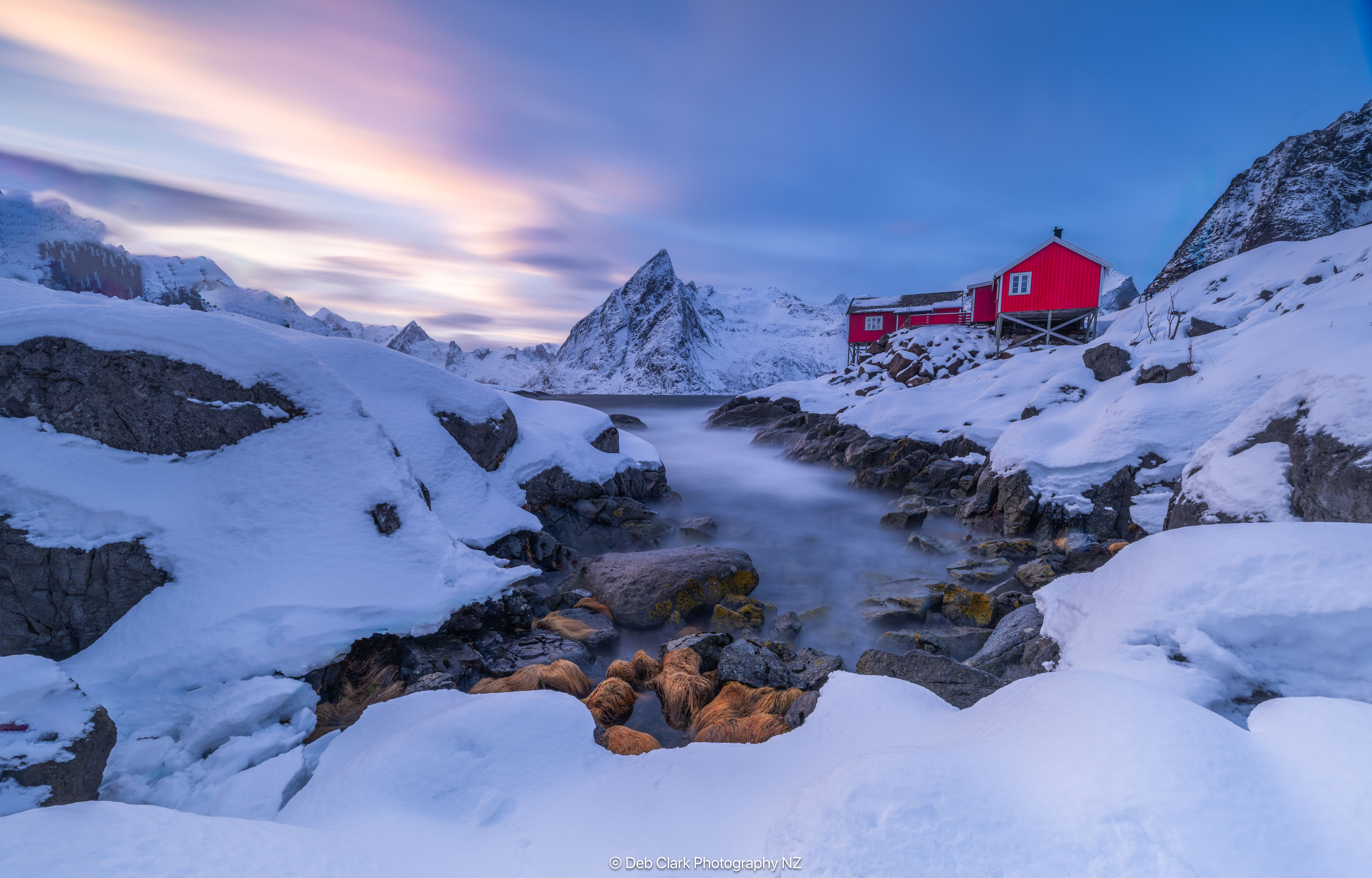 Blue sunrise and snowy mountain peak Eliassen, Reine, Norway
