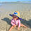 Thumbnail: Baby wearing Toddler size NAV BCH straw hat while playing in the water on Navarre Beach