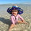 Thumbnail: Baby wearing Toddler size NAV BCH straw hat while playing in the water on Navarre Beach