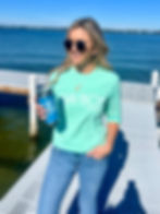 Thumbnail: Woman on Navarre Beach wearing NAV BCH long sleeve shirt in Island Green color
