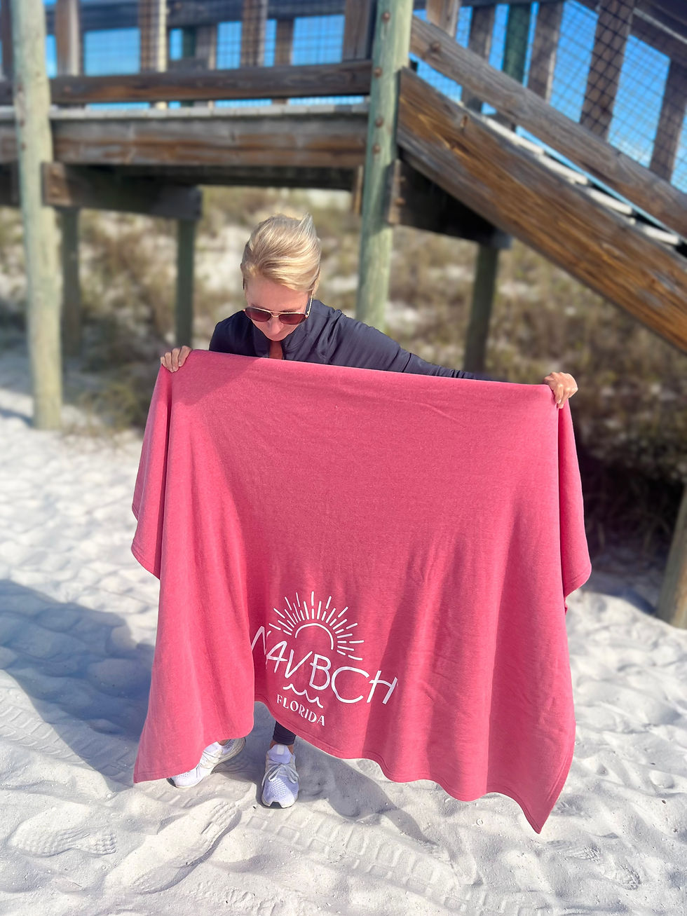 Thumbnail: Girl with NAV BCH Bright Coral color beach blanket on Navarre Beach