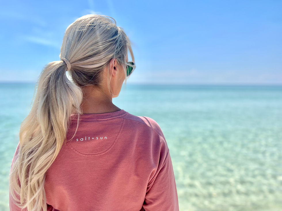 Thumbnail: Girl on Navarre Beach wearing NAV BCH Crewneck Sweatshirt in Bright Coral Color
