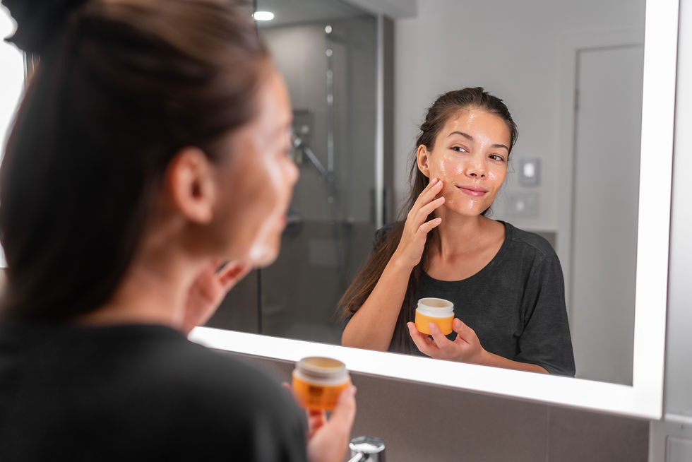 Woman in bathroom putting honey of her face.