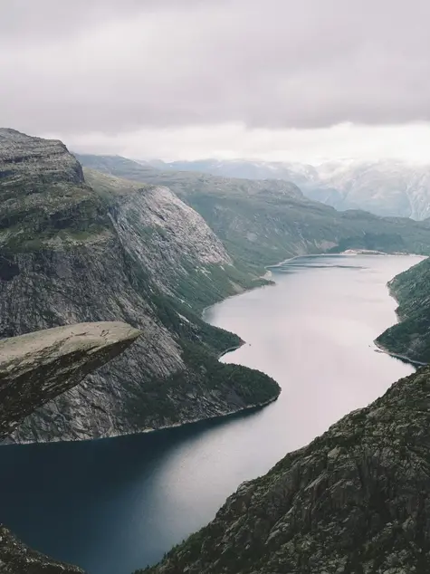 The Trolltunga rock ledge jutting out above a lake.