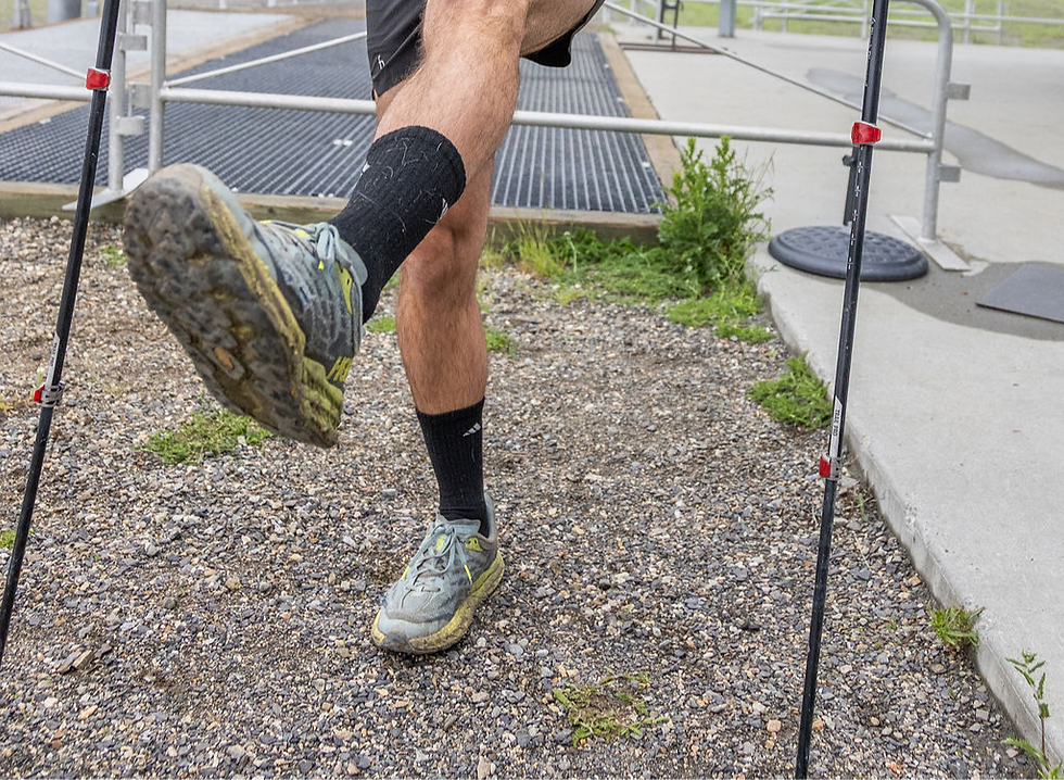Close-up view of a runner’s ankle with supportive trail running shoes on a dirt path