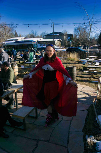 Person posing in costume with red cape