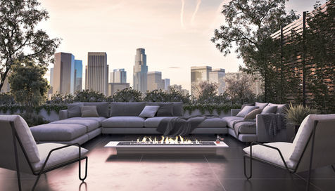 Rooftop terrace with sectional seating, fire pit, landscaping, and the Los Angeles skyline in the distance.