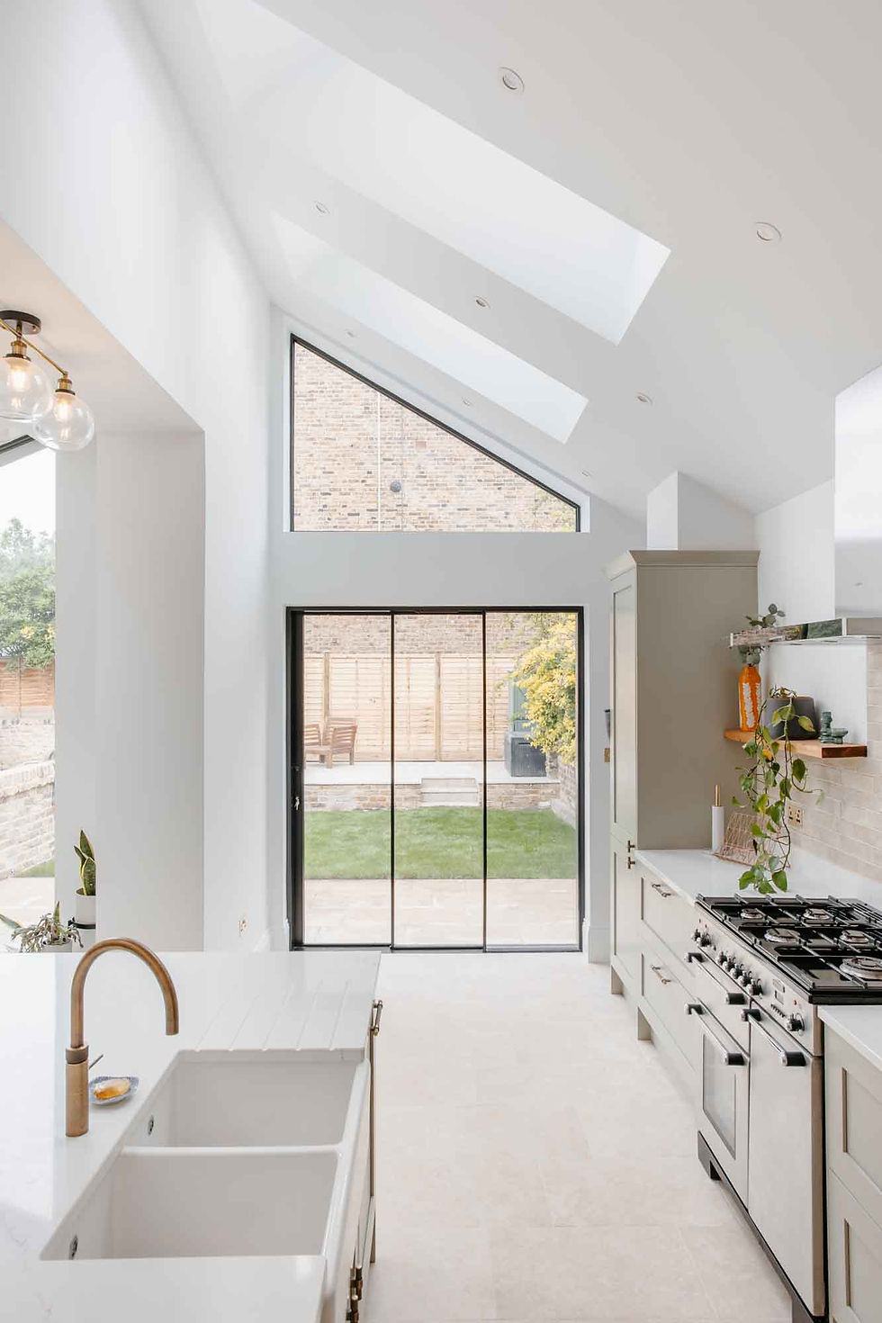 View from the kitchen through rear glass doors overlooking the garden.