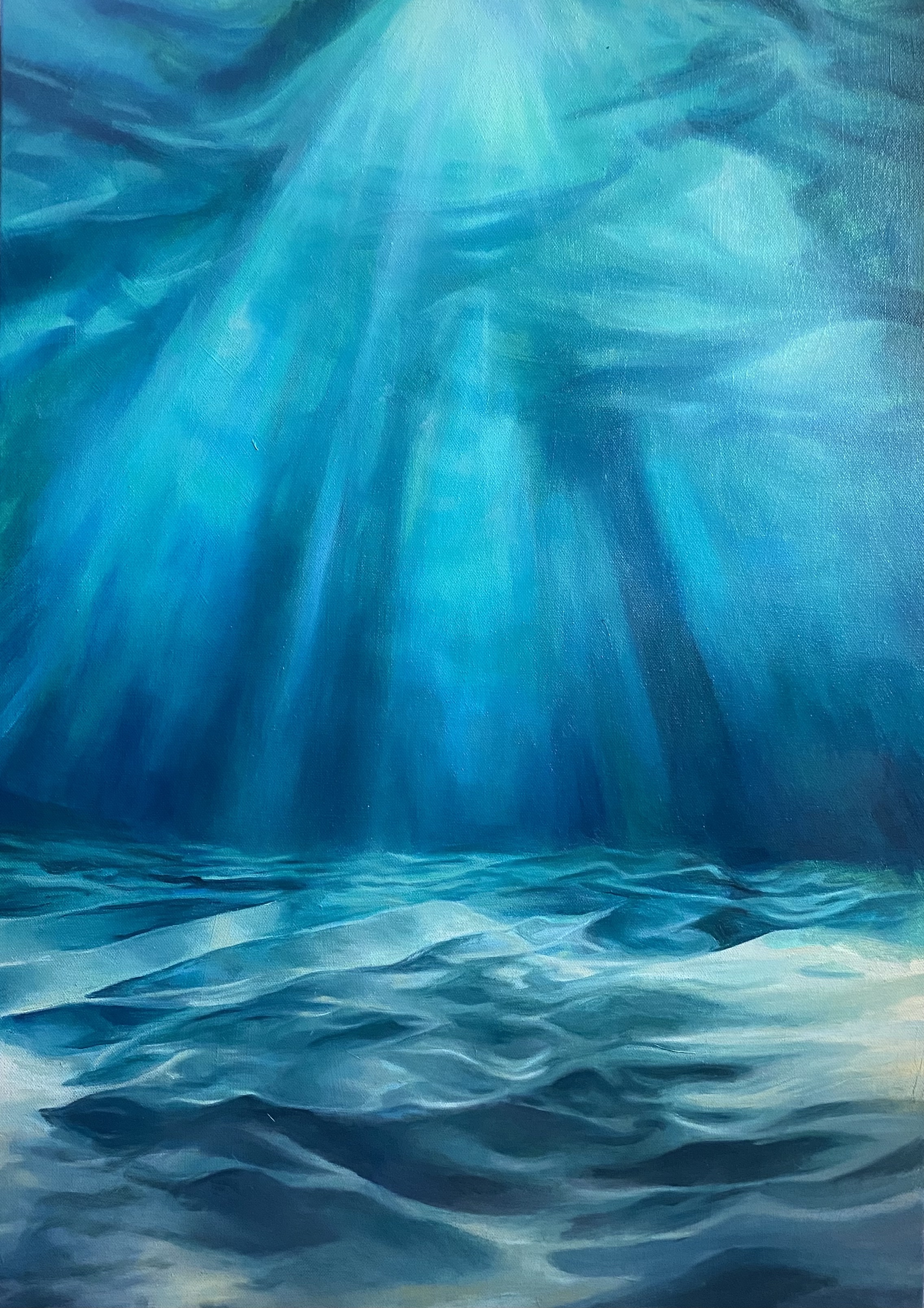 Shafts of sunlight passing through blue water
