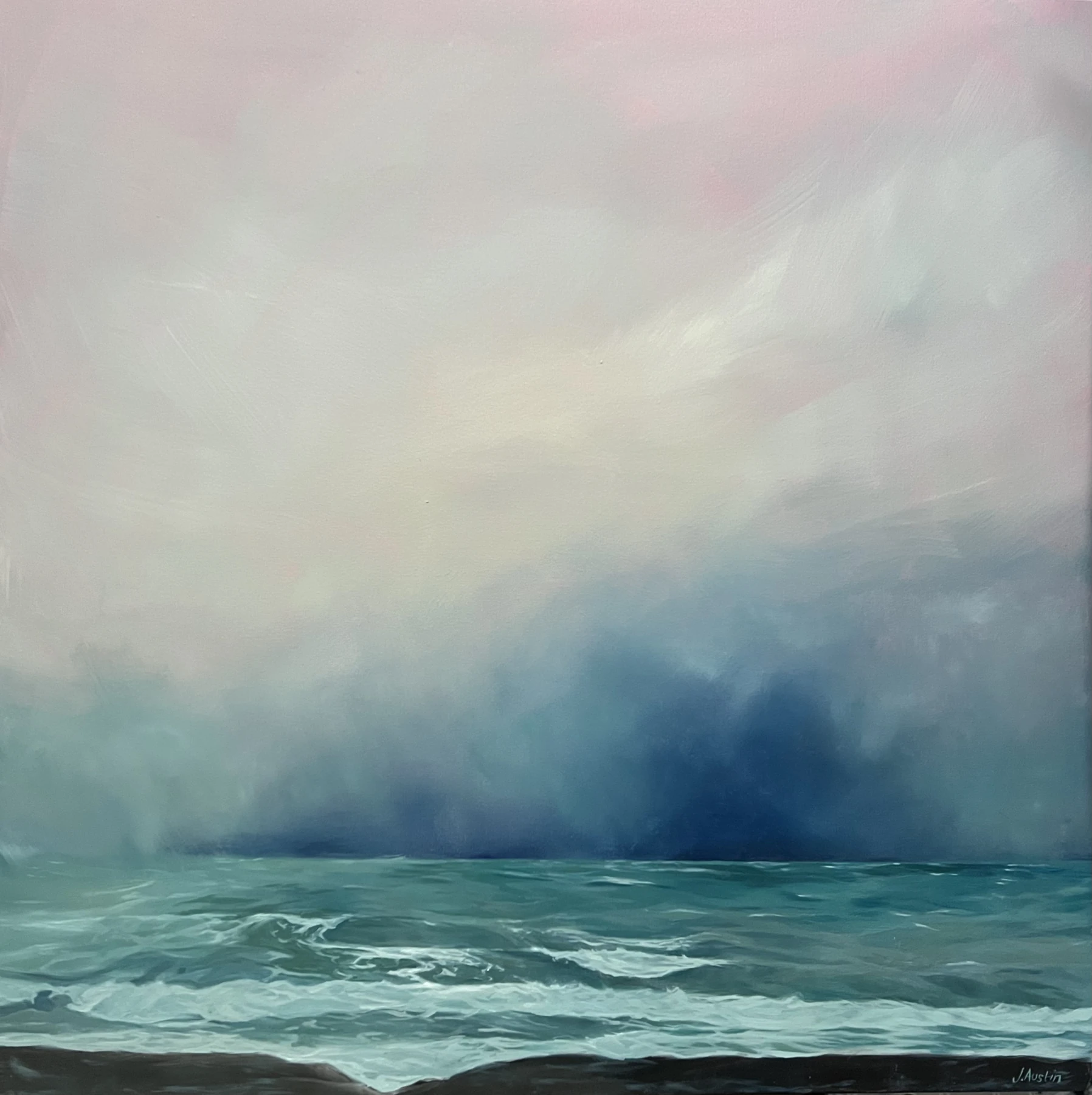 A snowstorm gathering above a pale green Orkney sea