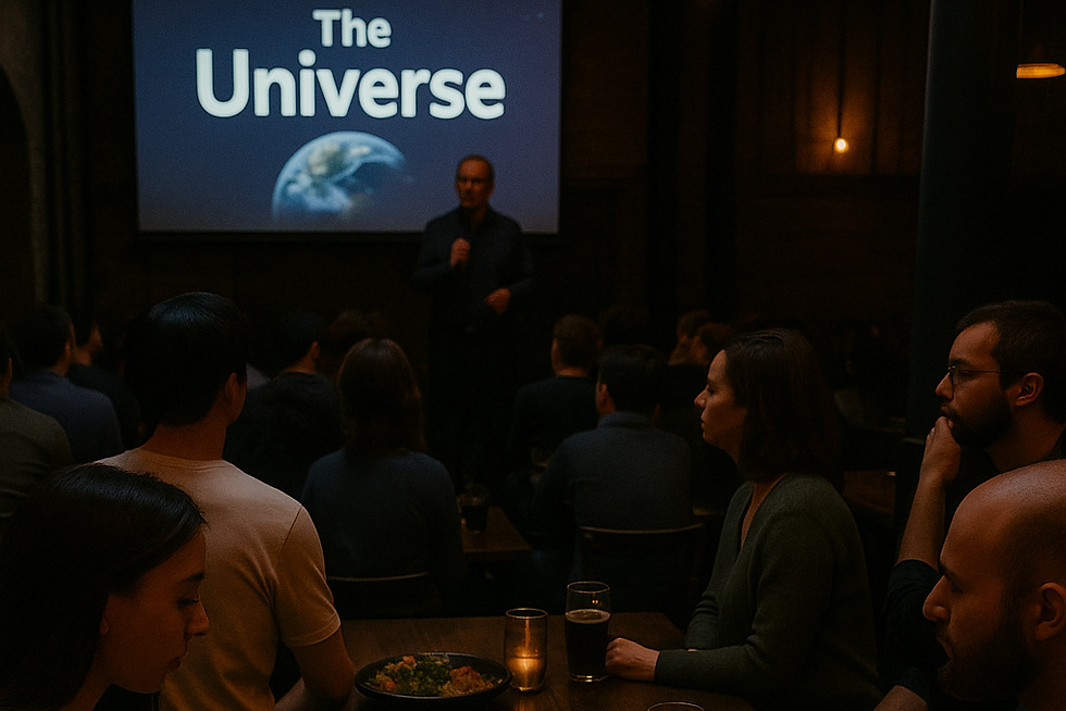Audience seated at wooden tables in a dimly lit pub, listening to a speaker give a talk with a projector screen in the backgr