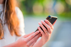 closeup-of-female-hands-is-holding-cellphone-outdo-2022-03-30-00-27-11-utc