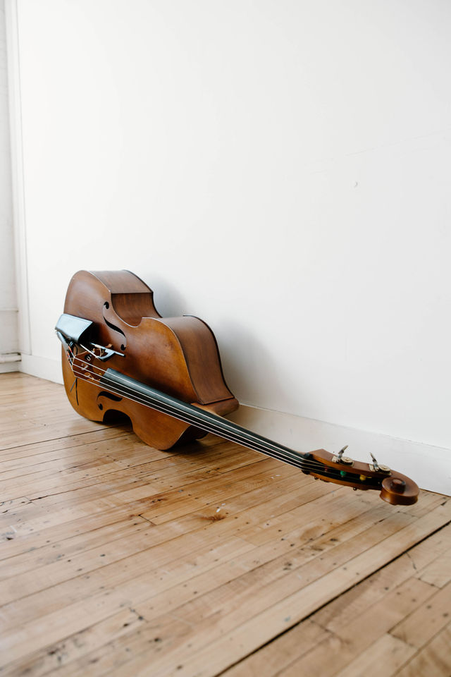 upright bass laying on the floor of a studio room