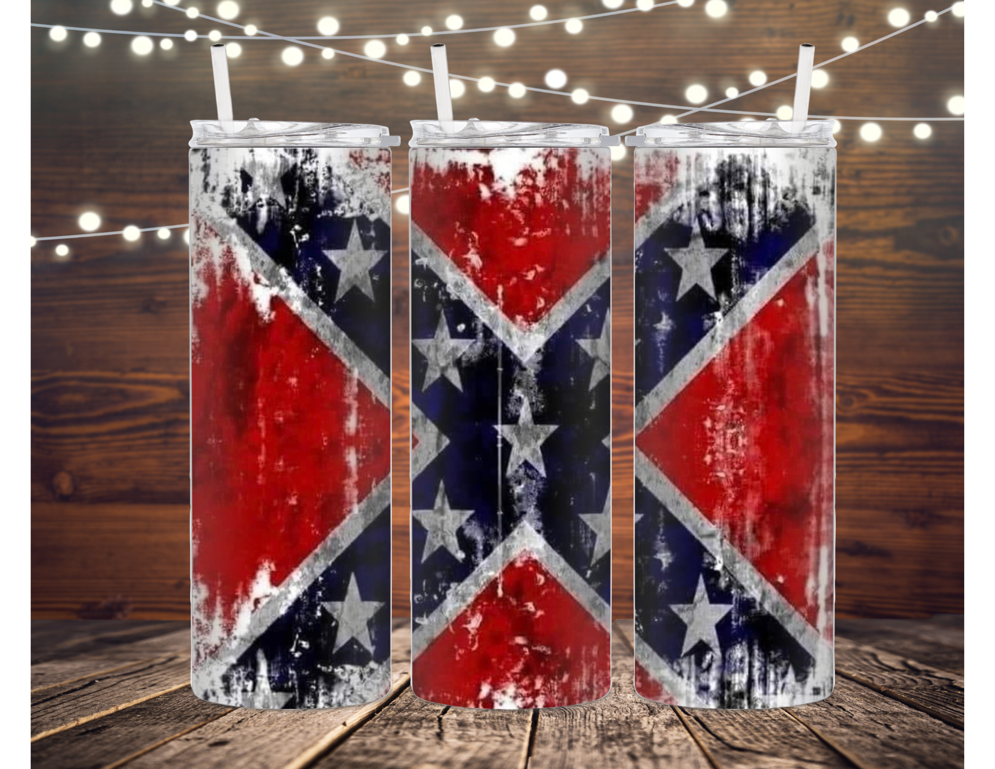 Three skinny tumblers with distressed Confederate flag design on wood.