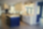 Large white kitchen with blue island