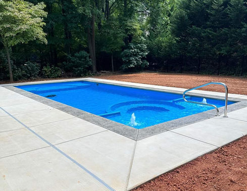 Caesars Palace large fiberglass pool surrounded by landscaping in Hampton Roads