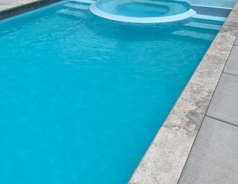 Caesars Palace large fiberglass pool with integrated spa and tanning ledge