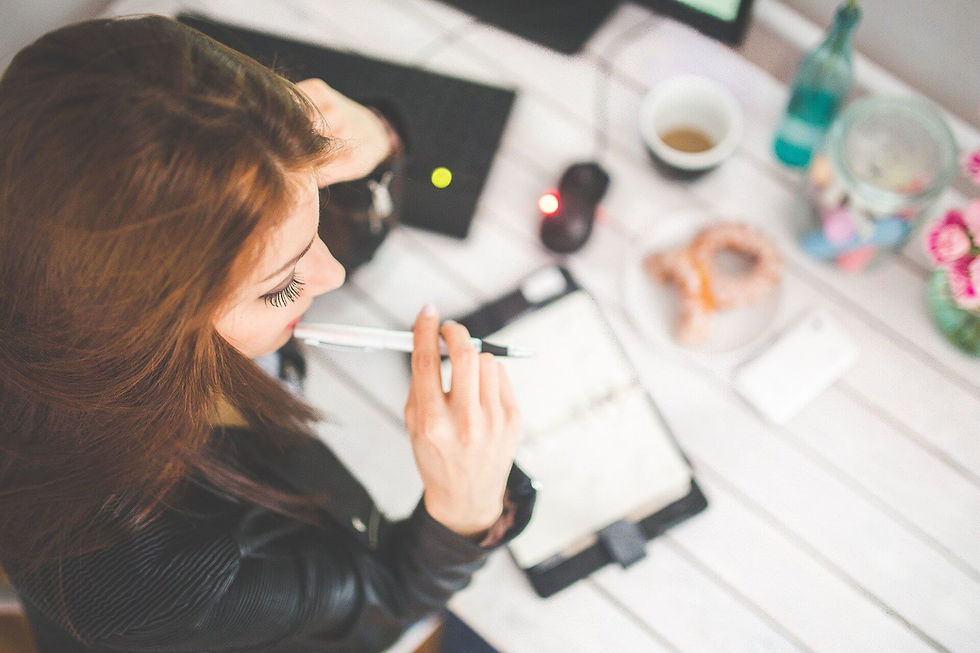 woman taking notes at a desk