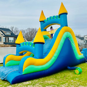 A photo of a blue, yellow, and teal bouncy castle slide.