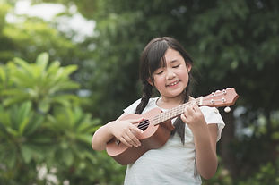 Beautiful asian girl playing ukulele, Ou