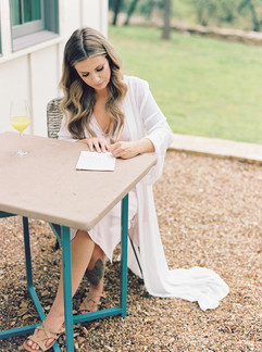 bride writing her vows before her wedding