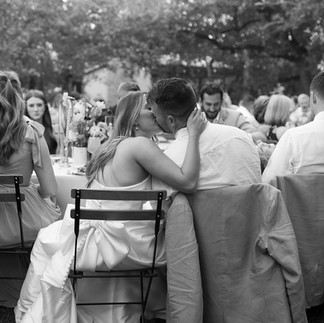 bride and groom kissing at their reception at the wayback
