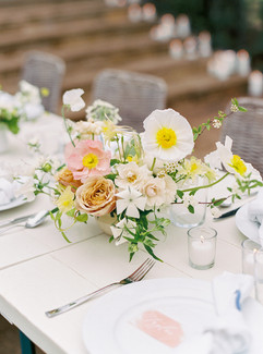 wedding reception tables with peach, orange, and yellow flowers