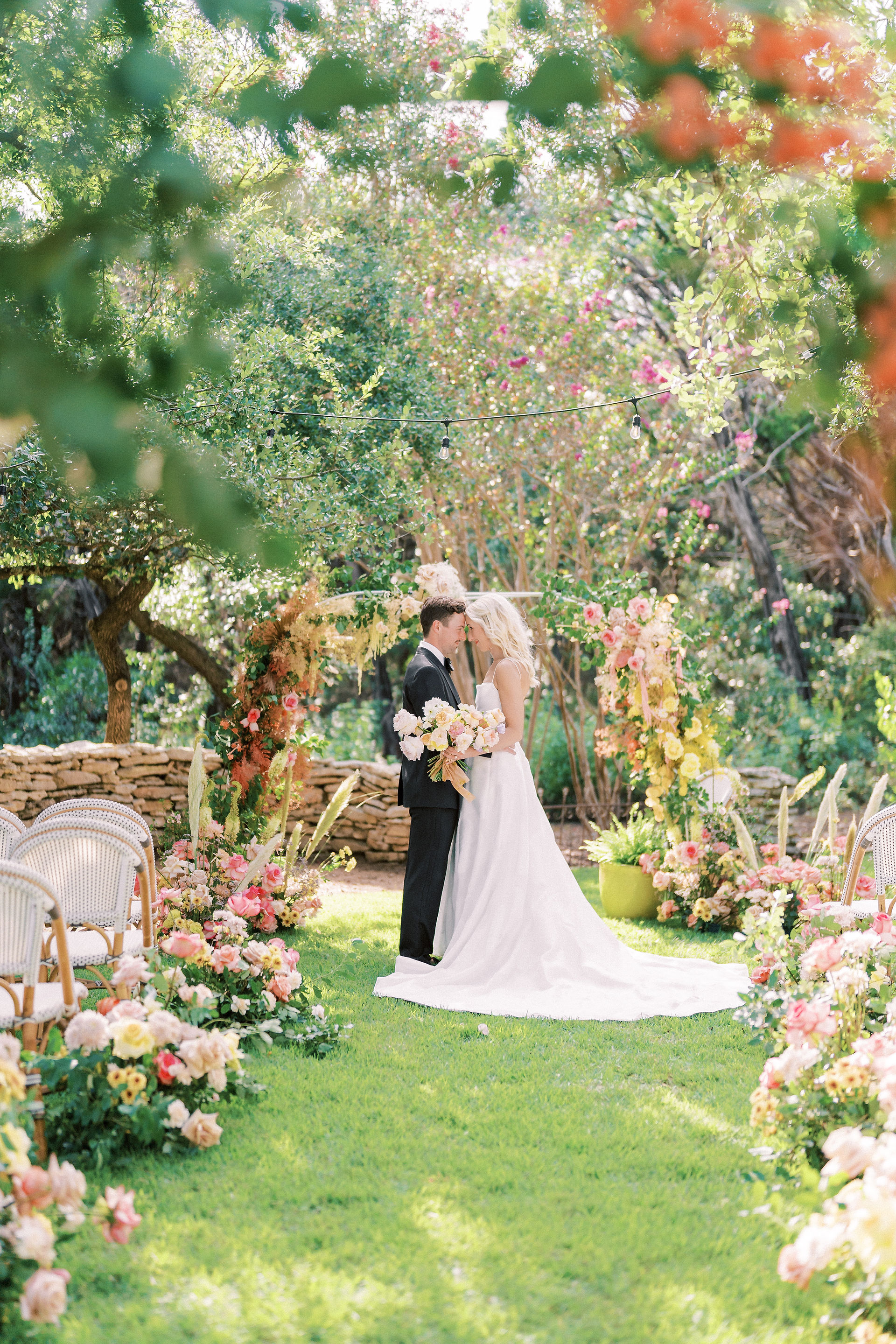a bride and groom embracing at the altar