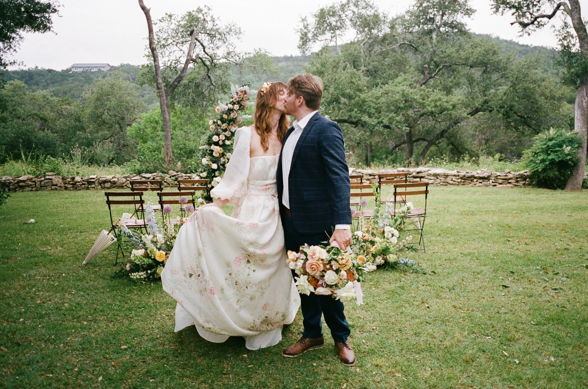 Bridal Model wearing a monique lhuillier wedding dress kissing her groom model at The Wayback in Austin Texas