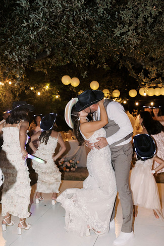 a wedding couple dancing and kissing during their wedding reception