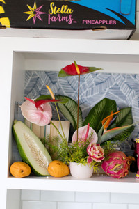 colorful tiki bar decorations of flowers and fruit inside the cabana at the wayback during a wedding reception