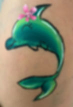 Green dolphin face painting with pink flower