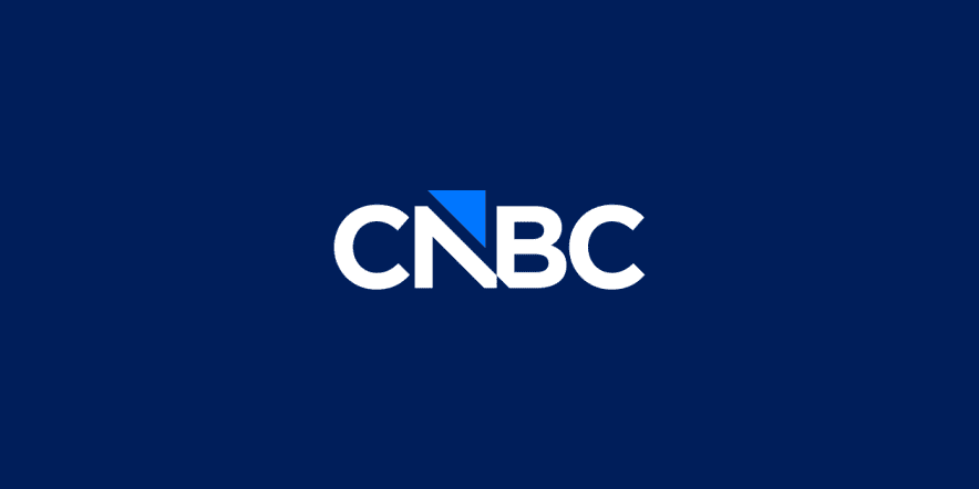 CNBC business news channel studio with anchors and live stock market updates on screen