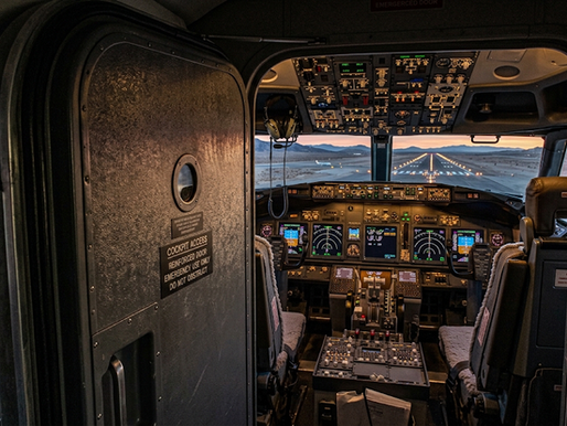 Empty airliner cockpit with the reinforced door open at dawn, illustrating the insider threat exposed by the Flydubai hijacking attempt.