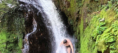 White cascade plunging through a narrow moss-covered gorge in Khao Sok