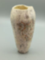 Handbuilt raku vase with ivory glaze and fine orange and black line detail, studio lighting on grey base.