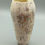Thumbnail: Handbuilt raku vase with ivory glaze and fine orange and black line detail, studio lighting on grey base.