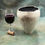 Thumbnail: White Crackle Raku Vessel from the Raku collection Raku glazed and fired white crackle vessel with wine glass and cork.