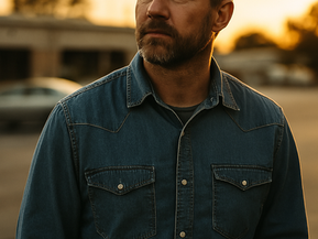 A middle-aged man standing outside in a parking lot at sunset, reflecting on proving your worth at work after years of loyalty and hard work