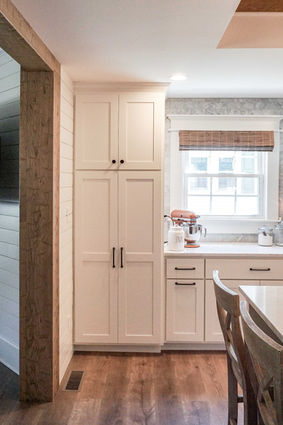 Custom tall pantry cabinets providing organized kitchen storage