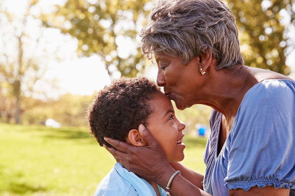 Grandmother embracing grandson in a UK park