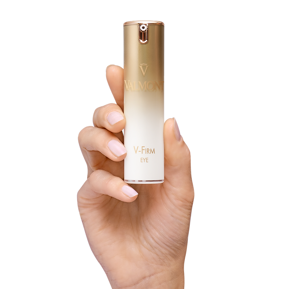 Hand presenting V-Firm Eye gold pump bottle against white background