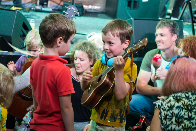 Children playing a Ukelele.